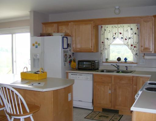 786 Garner Run Road Waynesburg, PA 15370 - Photo 4 of 8 Kitchen. Kitchen features center island. The refrigerator shown will not stay. There is an original white refrigerator without icemaker that will be moved back upstairs to replace. Sliding doors off the dining room exits to the deck in the rear.