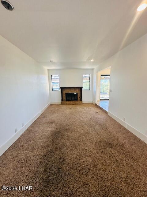 31632 Treasure Road Parker, AZ 85344 - Photo 5 of 26 an empty room with fireplace and windows
