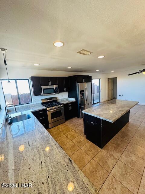 31632 Treasure Road Parker, AZ 85344 - Photo 8 of 26 a kitchen with stainless steel appliances kitchen island granite countertop a stove and a sink