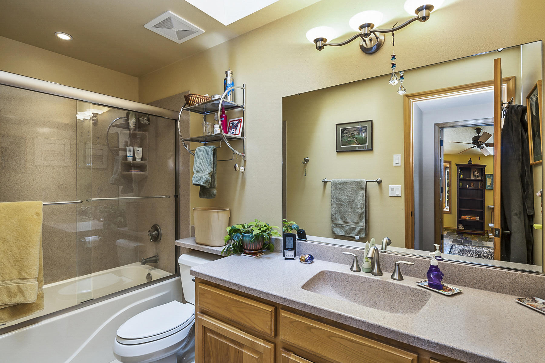 64477 Joe Neil Road Bend, OR 97701 - Photo 23 of 39 a bathroom with a granite countertop sink toilet and shower