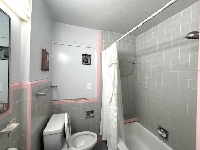 a white toilet sitting next to a bathroom sink and vanity