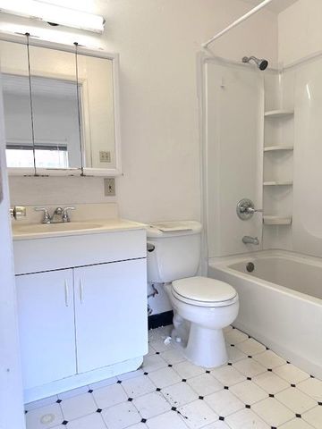a bathroom with a sink toilet vanity and shower