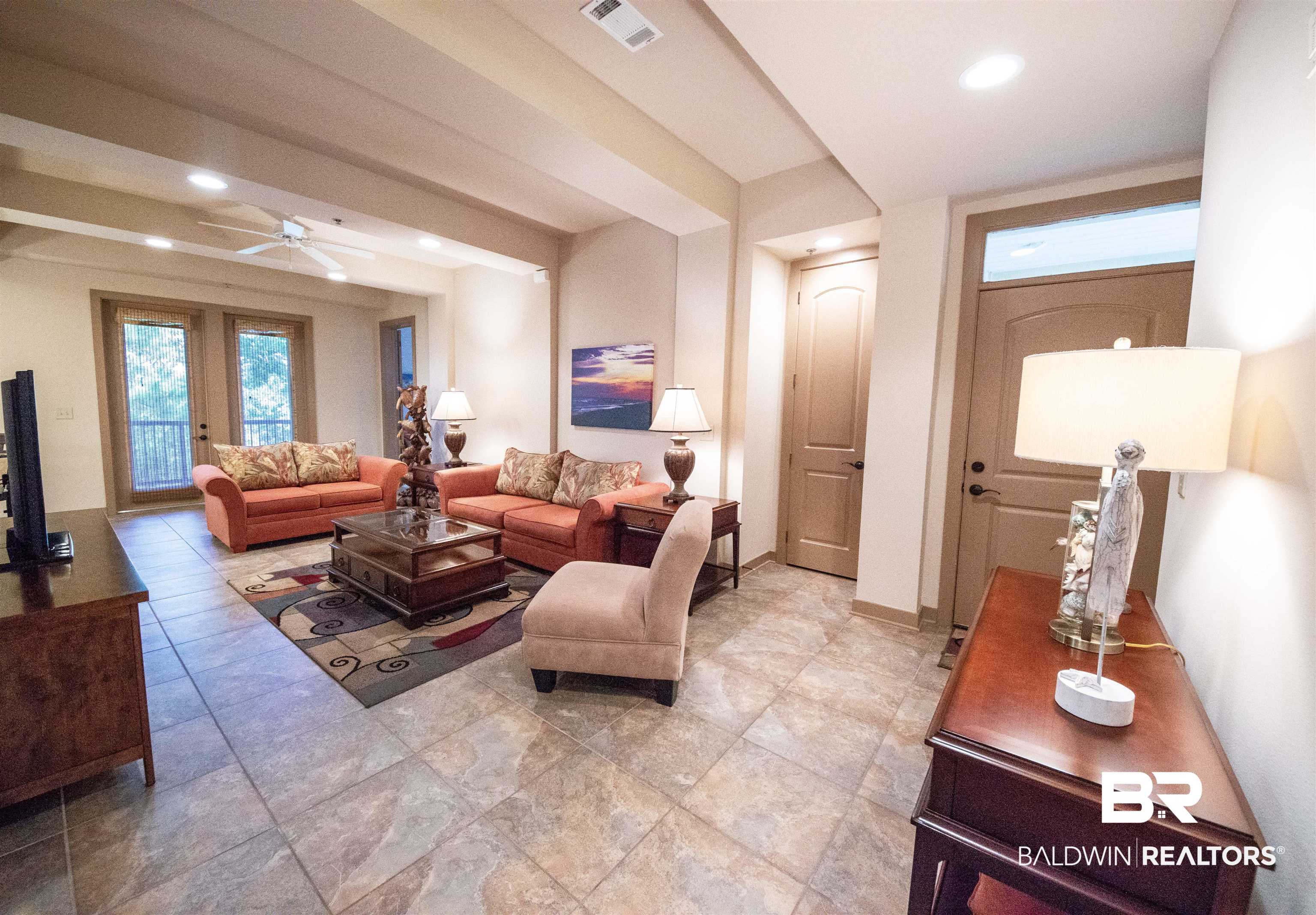 1430 Regency Road, Unit 301C Gulf Shores, AL 36542 - Photo 20 of 22 Living room with tile patterned floors, french doors, and ceiling fan