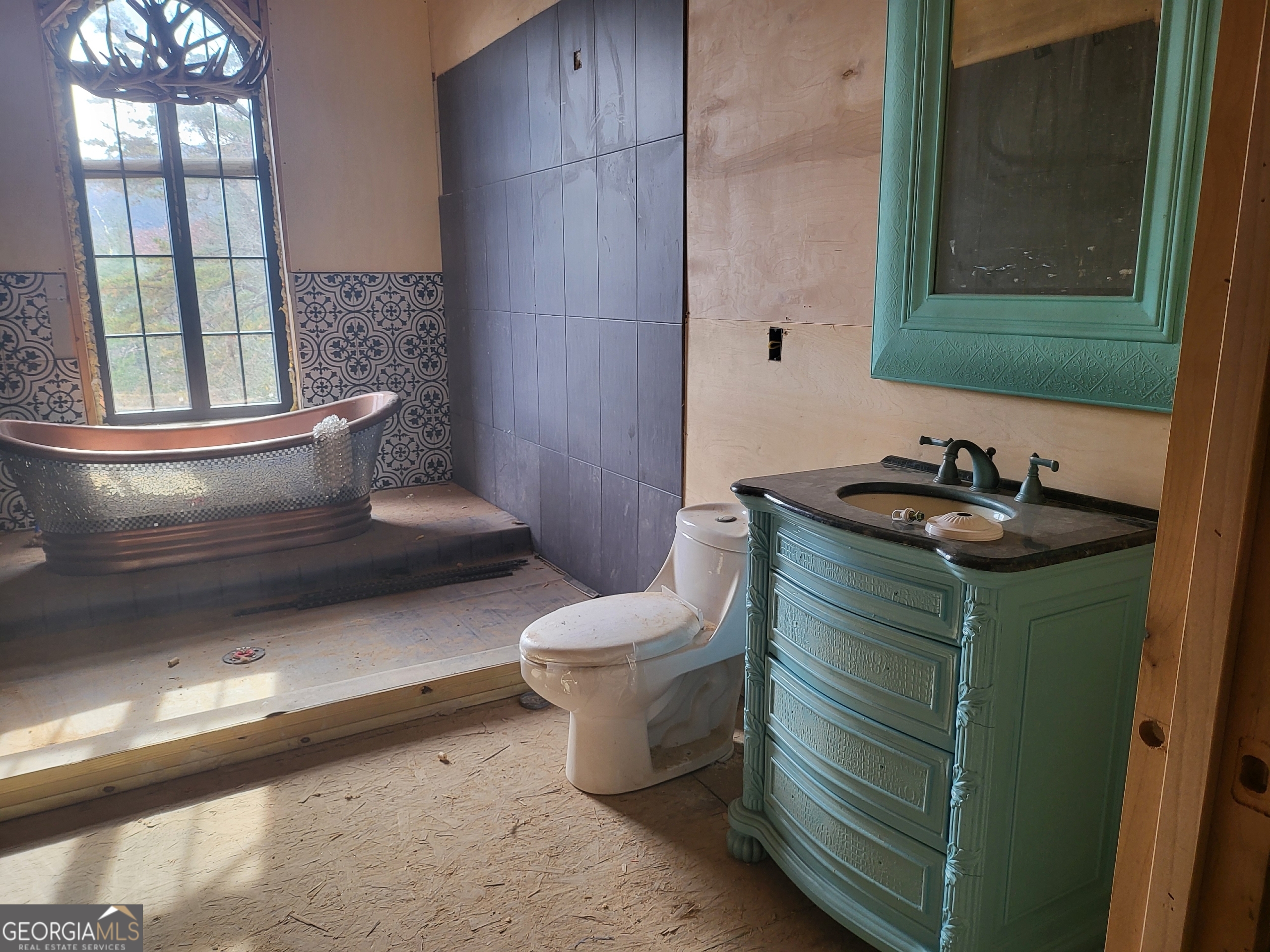 389 Fort Mountain Road Blairsville, GA 30512 - Photo 22 of 30 a bathroom with a toilet sink and mirror
