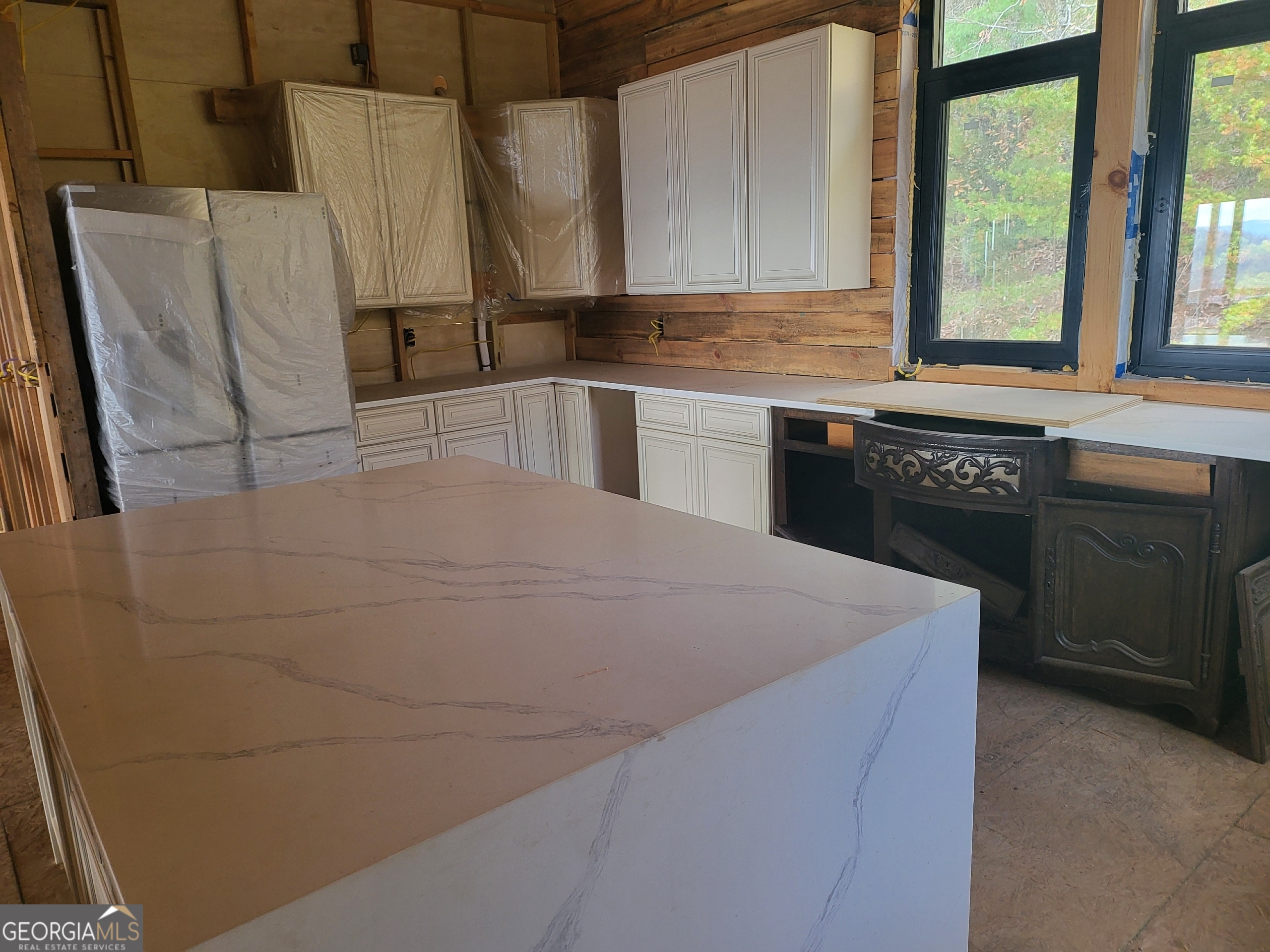 389 Fort Mountain Road Blairsville, GA 30512 - Photo 9 of 30 a kitchen with granite countertop a sink a stove and refrigerator