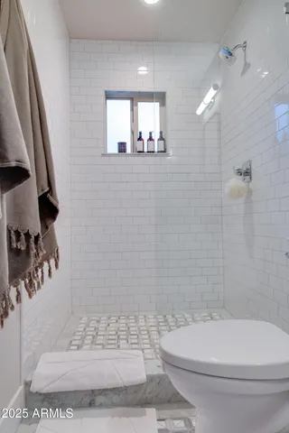 a bathroom with a toilet a sink and shower