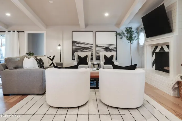 a living room with fireplace furniture and a flat screen tv