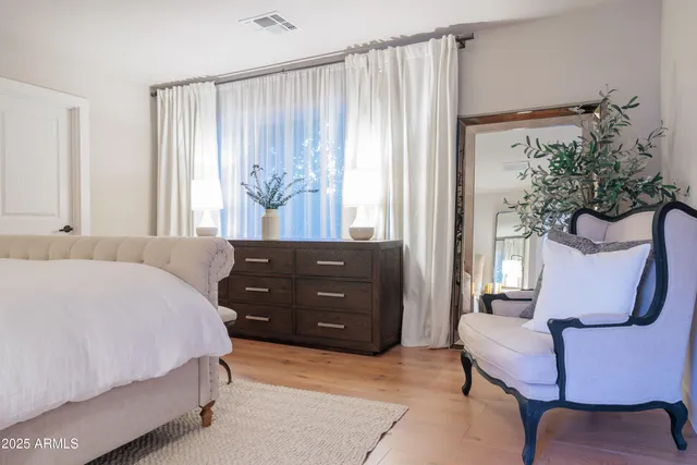 a bedroom with a bed and a mirror