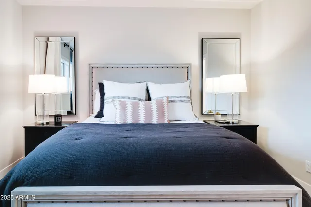 a bedroom with a bed and a lamp