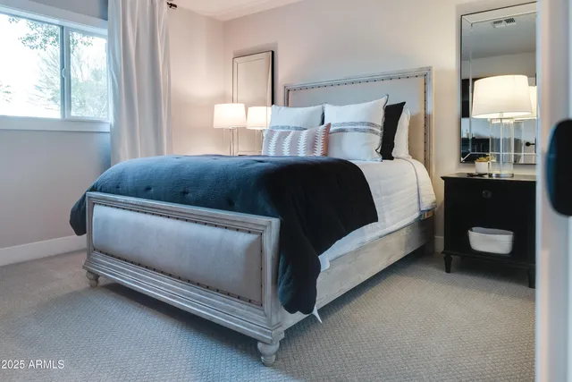 a bed room with a bed and a lamp