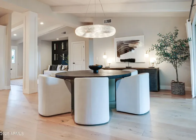 a living room with kitchen island furniture and a chandelier