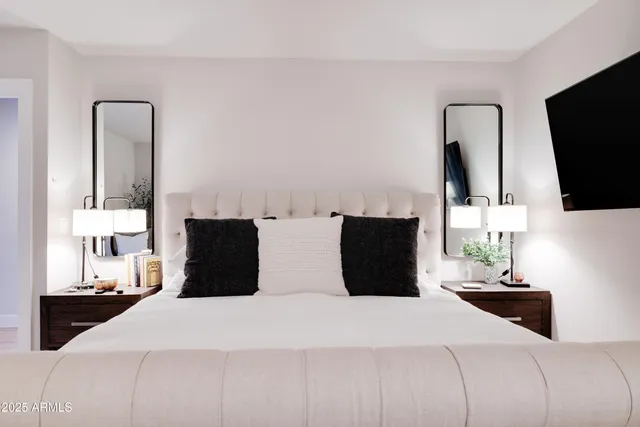 a bedroom with a bed and a flat screen tv