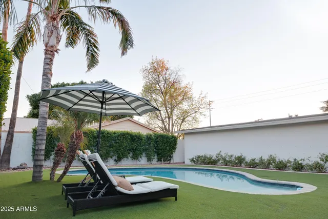 a view of outdoor space with swimming pool and furniture