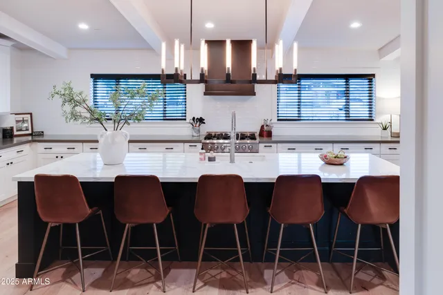 a kitchen with stainless steel appliances a sink and cabinets