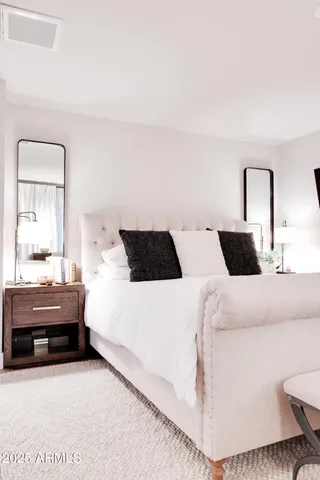 a bedroom with a bed and a couch