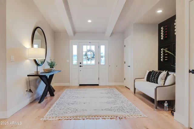 a living room with furniture a rug and a chandelier