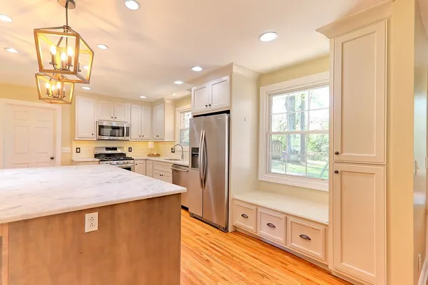 a kitchen with stainless steel appliances a refrigerator sink and cabinets
