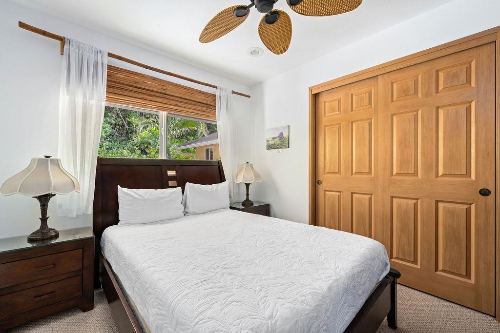 1444 West Kuiaha Road Haiku, HI 96708 - Photo 13 of 30 a bedroom with a bed and a large window