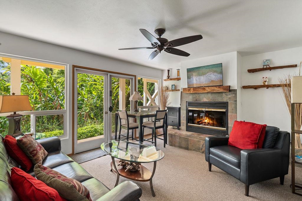 1444 West Kuiaha Road Haiku, HI 96708 - Photo 15 of 30 a living room with furniture a fireplace and a floor to ceiling window