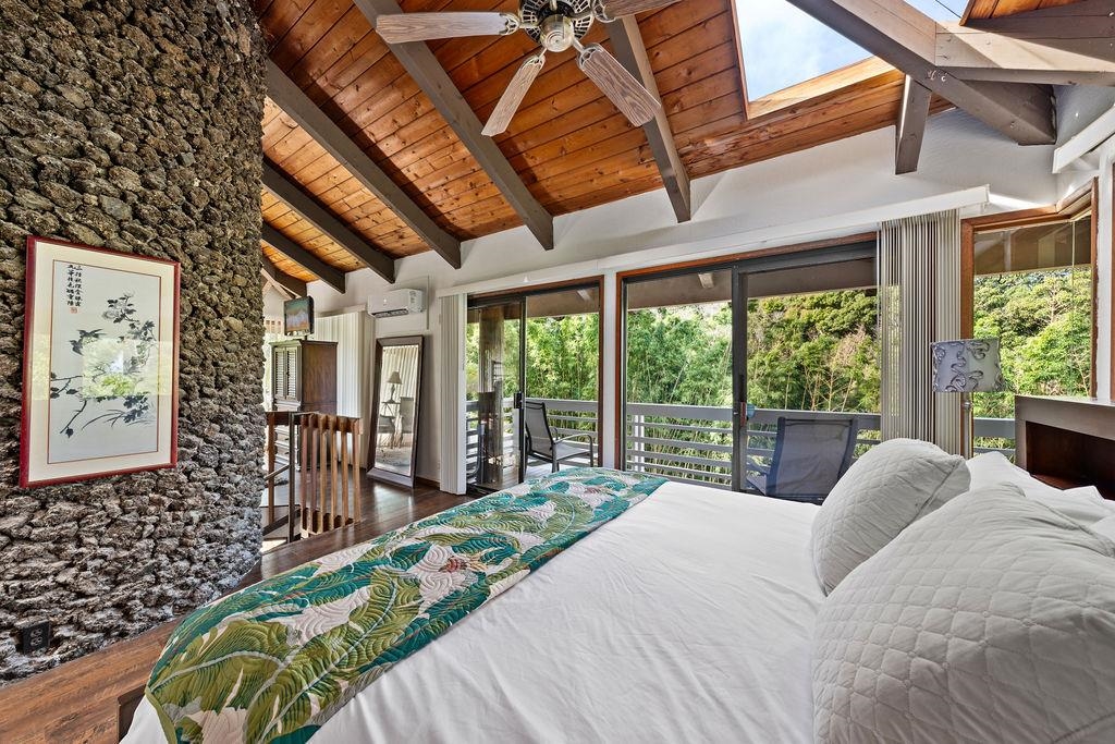 1444 West Kuiaha Road Haiku, HI 96708 - Photo 24 of 30 a bed sitting in a bedroom next to a large window