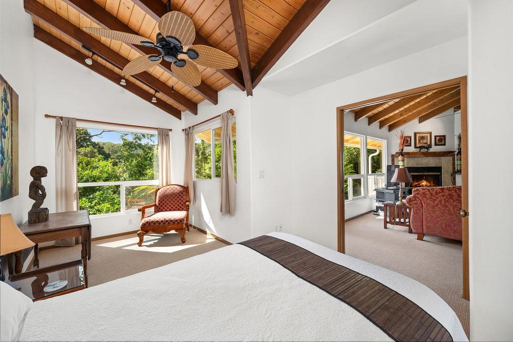 1444 West Kuiaha Road Haiku, HI 96708 - Photo 8 of 30 a bedroom with furniture large window and a flat tv screen