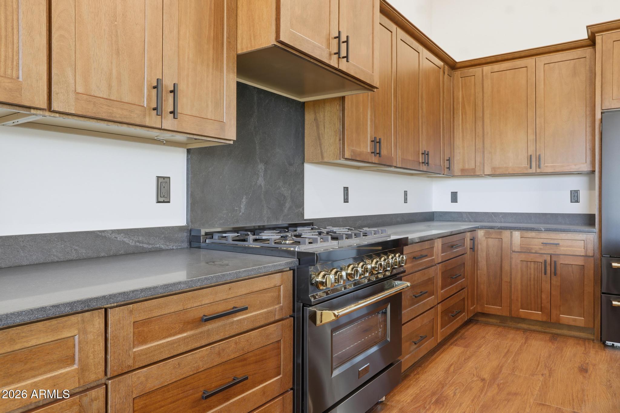 1112 South Kinzer Court Payson, AZ 85541 - Photo 11 of 41 a kitchen with stainless steel appliances granite countertop a stove a sink and a white cabinets