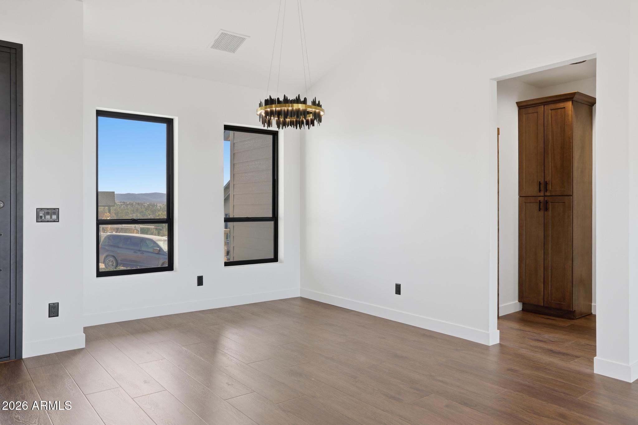 1112 South Kinzer Court Payson, AZ 85541 - Photo 10 of 41 an empty room with wooden floor and windows