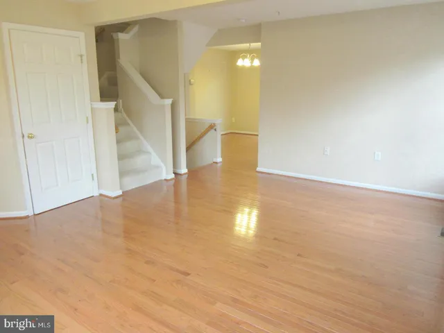 a view of an empty room with stairs and ventilation