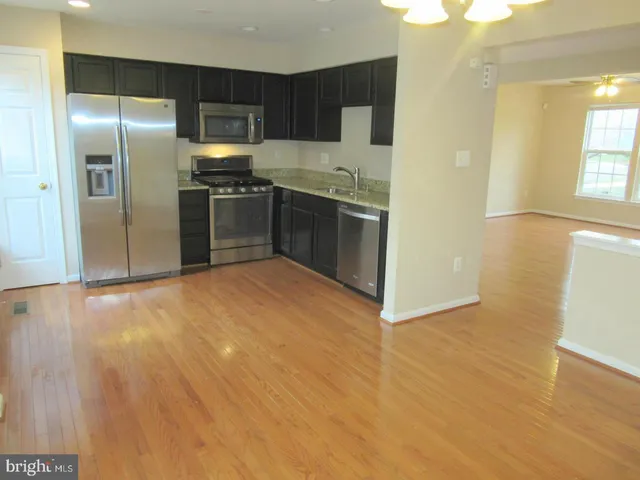 a kitchen with stainless steel appliances a refrigerator and a sink