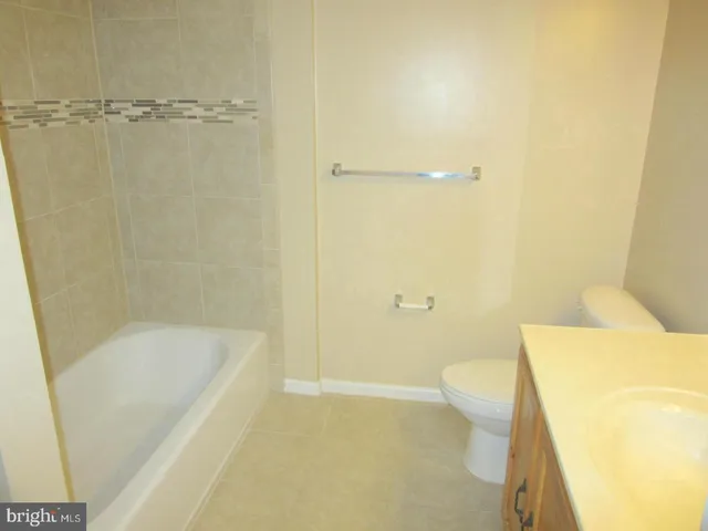 a bathroom with a bathtub and a toilet