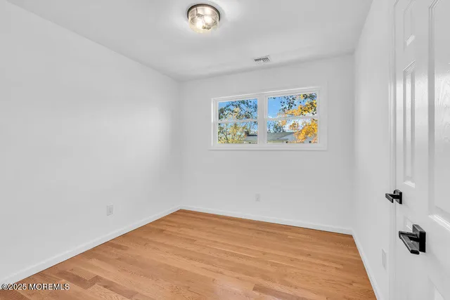 an empty room with a painting on the wall