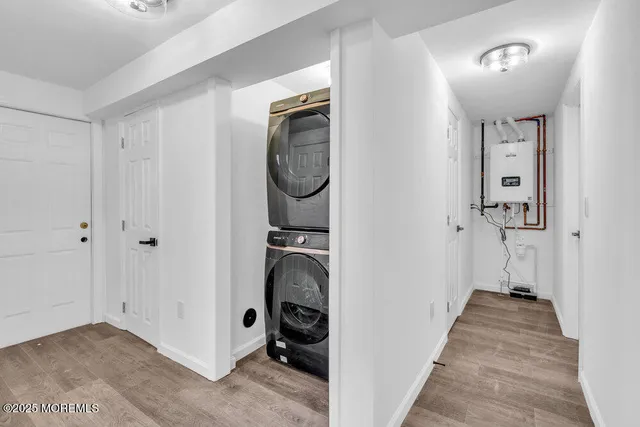 a view of a hallway with closet and utility room