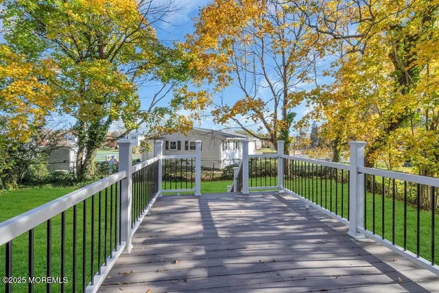 a view of a house with a small yard and wooden fence