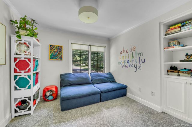 a living room with lots of furniture and a window