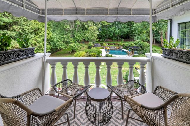 a balcony view with a seating space