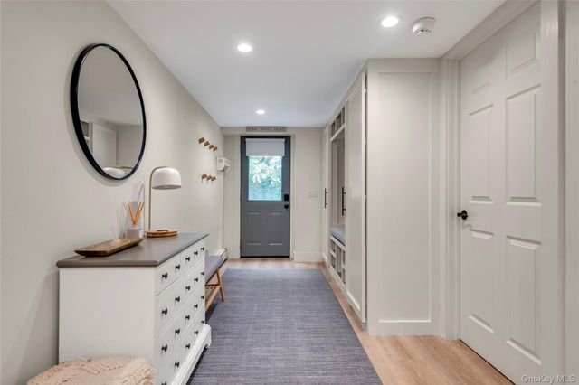 a very nice looking bathroom with a large mirror and a wooden floor