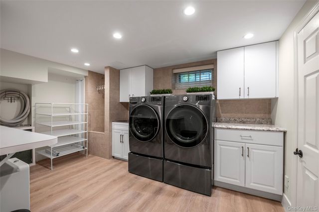a utility room with sink dryer and washer