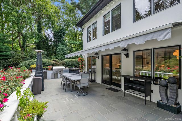 a view of a patio with a table and chairs and potted plants