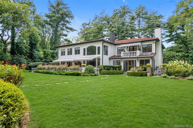 a front view of a house with a yard table and chairs