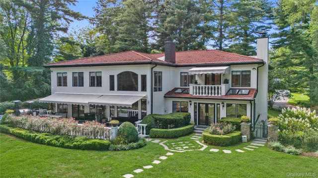 a front view of a house with a yard table and chairs