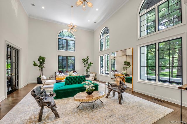 a living room with patio furniture and a large window