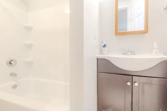 a bathroom with a sink a mirror and a bathtub