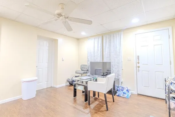 a view of a livingroom with furniture and a window