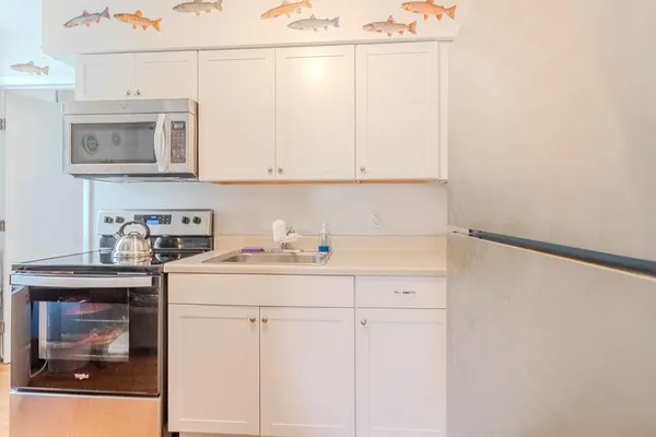 a kitchen with a white cabinets and white appliances