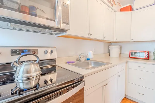 a kitchen with a sink cabinets and appliances