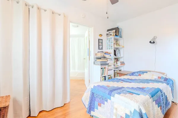 a bedroom with a bed and a window