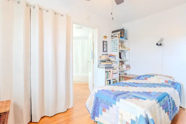 a bedroom with a bed and a window