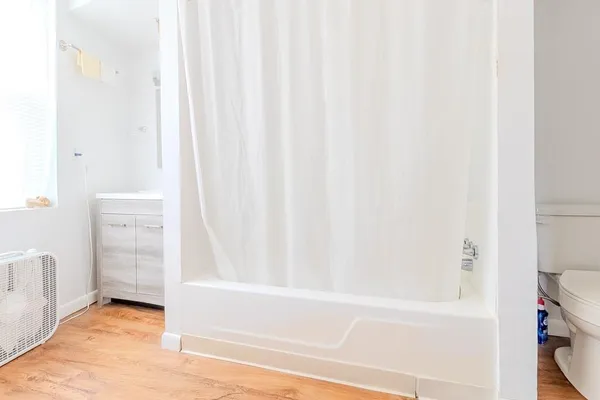 a bathroom with a bathtub and shower