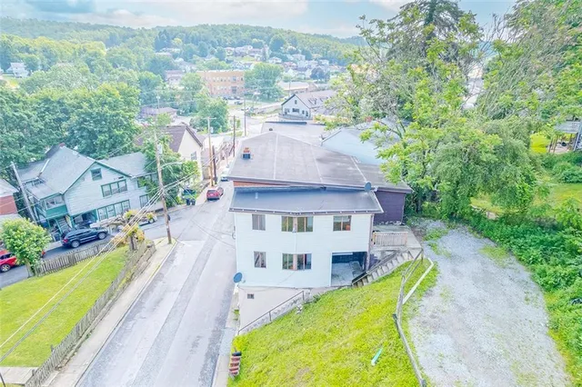 an aerial view of a house with a swimming pool