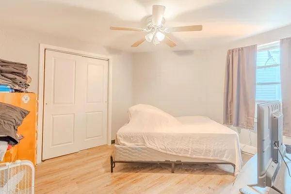 a bedroom with a bed and a chandelier